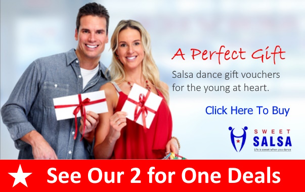 Smiling couple holding salsa gift vouchers
