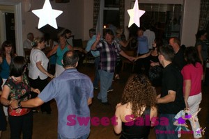 Teacher leads a rueda or Cuban Wheel at the salsa party