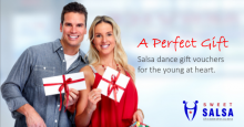 young couple holding salsa gift vouchers